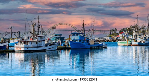 Newport, Oregon - 3-9-2021: Panorama of Commercial fishing boats at sunset in harbor at Newport Oregon
