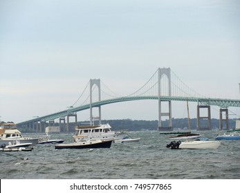 NEWPORT, RHODE ISLAND—SEPTEMBER 217: The Claiborne Pell Newport Bridge connecting Newport to Jamestown, with boats and yachts floating in the water on a windy stormy day.