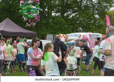 Newport Wales UK 05/19/2019  Charity Fun Run At Tredegar Park. Kolor Dash- Coloured Powder Paint Similar To People Being Covered With Powder At Holi Festival. People Taking After Race Photos.