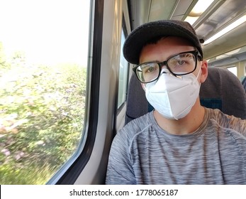 Newport, Wales/UK - 07/17/2020: A Man Passenger Sitting On A Transport For Waled Train, Travelling From Newport To Abergavenny. It's A Legal Requirement To Wear A Face Mask On All Public Transport.