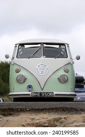 NEWQUAY, ENGLAND - AUGUST 1, 2013: An old Volkswagen camper van parked in the Fistral Beach car park on August 1, 2013 in Newquay. 