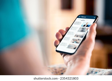 News online. Mobile phone screen. Senior woman reading newspaper on web portal and website. Latest daily information. Headlines on internet. Old person with smartphone. Misinformation, disinformation.