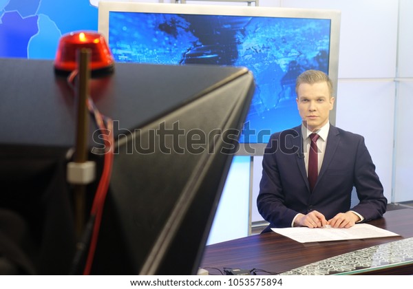 The news presenter reads the text on\
the teleprompter.Camera in the office. TV\
studio.