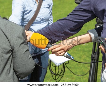 Similar – Image, Stock Photo Journalist holding microphone making media interview