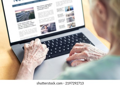 News website in laptop of an old woman. Elder senior and grandma reading digital newspaper with computer. Online magazine or web article in screen. Daily information publication site by the press.