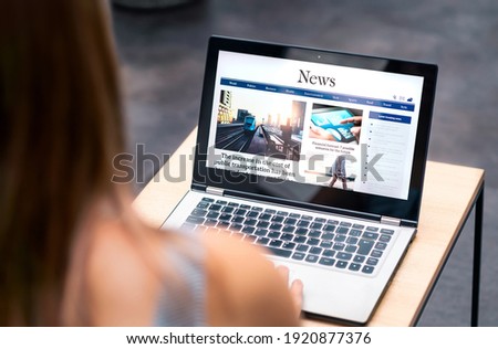 News website in laptop screen with online article and headline. Woman reading newspaper or magazine with computer. Digital web publication portal and internet page. Latest daily media site mockup.