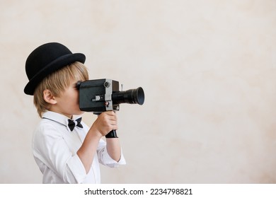 Newsboy shouting against grunge wall background. Kid selling newspaper. Child wearing vintage costume. Social media and Internet nerwork concept