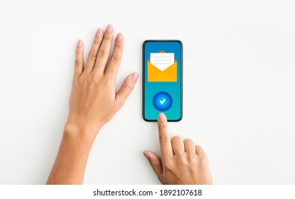 Newslettering Concept. Unrecognizable Female Using Smartphone With Opened Envelope Sign And Check Mark Button, Subscribed To Email Marketing, Creative Collage, Top View With Copy Space - Shutterstock ID 1892107618