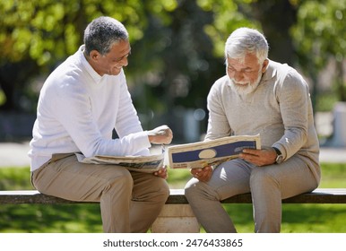 Newspaper, bench and senior men in park, sunshine and conversation with reading, bonding together and hobby. Old people, outdoor and relax with friends, communication and share info with happiness - Powered by Shutterstock