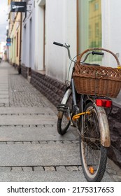 Newspaper In A Bicycle Basket Parked By A Old Tenemet House Wall In Świebodzice, Poland