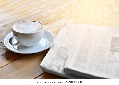 Newspaper And Coffee  On Office Desk