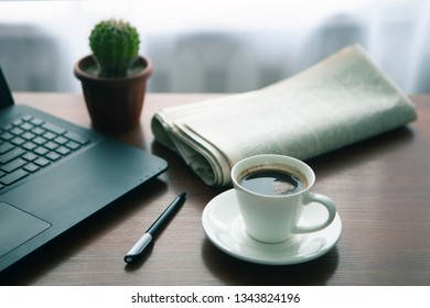 Newspaper with computer on table. Coffee break. 