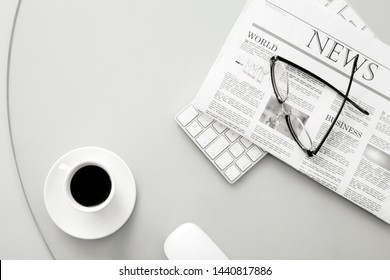 newspaper and eyeglasses over office desk - Powered by Shutterstock