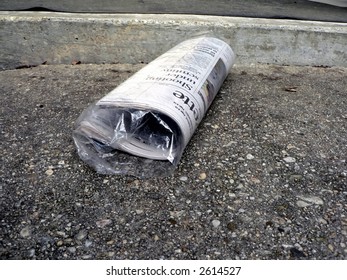 Newspaper Lying On Front Doorstep In A Protective Bag