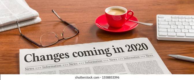 A newspaper on a wooden desk - Changes coming in 2020 - Shutterstock ID 1558853396