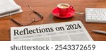 A newspaper on a wooden desk - Reflections on 2024