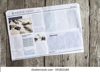 Newspaper On Wooden Table