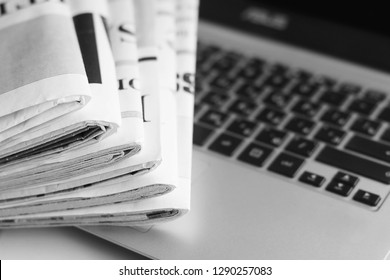 Newspaper Pages With Headlines And Articles On Keyboard Of Laptop. Latest News In Tabloid Journals And Computer. Offline And Online Information, Business And Technology Concept