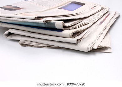 Newspaper Piled Up On A Table In A Office With White Background No People Stock Photo