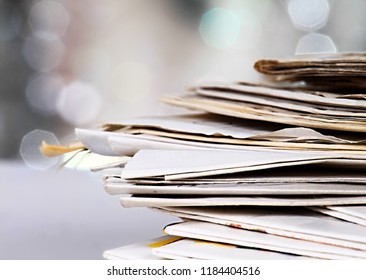 Newspaper Piled Up On A Table In A Office With White Background No People Stock Photo