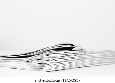 Newspaper Piled Up On A Table In A Office With White Background No People Stock Photo