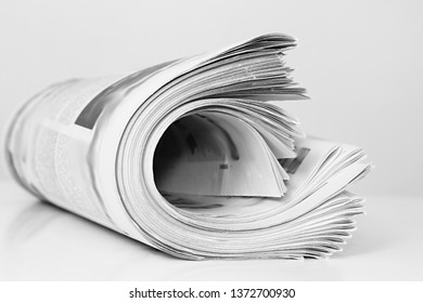 Newspaper Piled Up On A Table In A Office With Gray Background No People Stock Photo