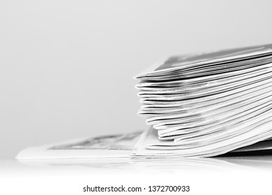 Newspaper Piled Up On A Table In A Office With Gray Background No People Stock Photo