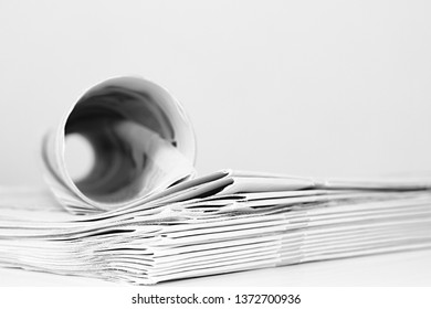 Newspaper Piled Up On A Table In A Office With White Background No People Stock Photo