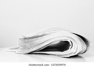 Newspaper Piled Up On A Table In A Office With White Background No People Stock Photo