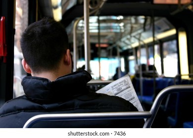 newspaper reader on bus