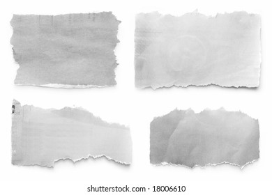 Newspaper tears collection, casting natural shadow on white.