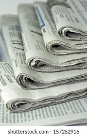 newspapers against plain background shot with very shallow depth of field