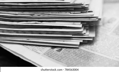 Newspapers for background. Old English daily papers with news on the table. Pages with headlines and articles folded and stacked, grange style. Blurred retro texture.                              - Shutterstock ID 784563004
