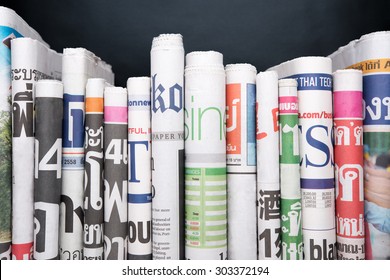 Newspapers folded and stacked - Shutterstock ID 303372194