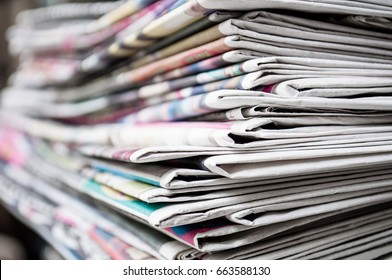 Newspapers Folded And Stacked On The Table Background. Colorful Newspaper. Image Shallow Depth Of Field.