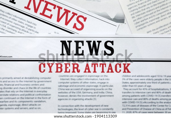 Newspapers with headline Cyber Attack as\
background, closeup