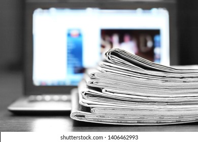 Newspapers and Laptop. Different Concepts for News -  Network or Traditional Tabloid Journals. Data Sources - Electronic Screen of Computer or Paper Pages of Magazines, Internet or Papers              - Shutterstock ID 1406462993