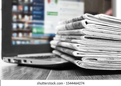 Newspapers and Laptop. Different Concepts for News -  Network or Traditional Tabloid Journals. Data Sources - Electronic Screen of Computer or Paper Pages of Magazines, Internet or Papers              - Shutterstock ID 1544464274