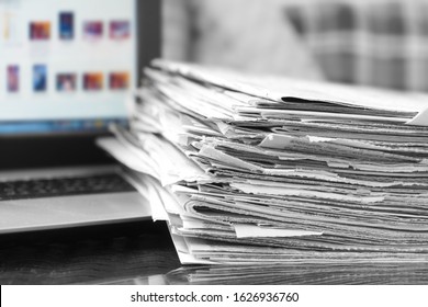 Newspapers and Laptop. Different Concepts for News -  Network or Traditional Tabloid Journals. Data Sources - Electronic Screen of Computer or Paper Pages of Magazines, Internet or Papers              - Shutterstock ID 1626936760