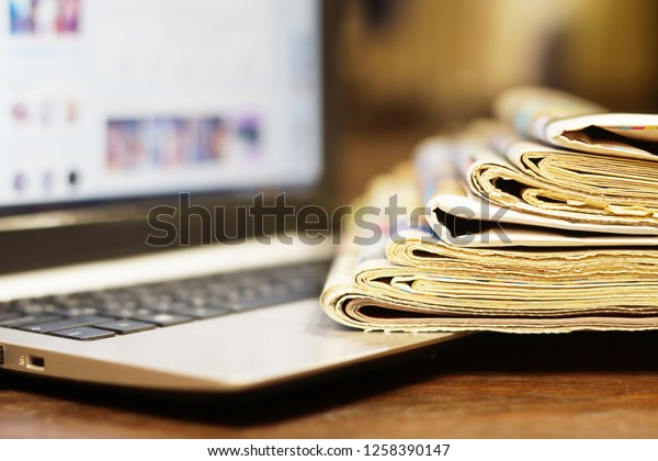Newspapers and Laptop. Different Concepts for News\
- Social Network or Traditional Tabloid Journals. Data Sources -\
Electronic Screen of Computer or Paper Pages of Magazines, Internet\
or Papers
