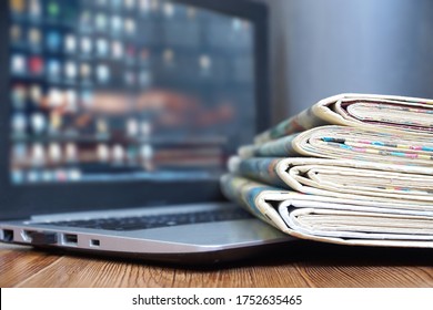 Newspapers and Laptop. Magazines and Journals and Computer. Paper Media and Electronic Device with Internet      - Shutterstock ID 1752635465