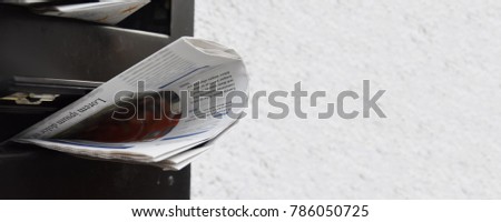 newspapers in a mailbox