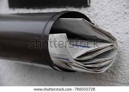 newspapers in a mailbox