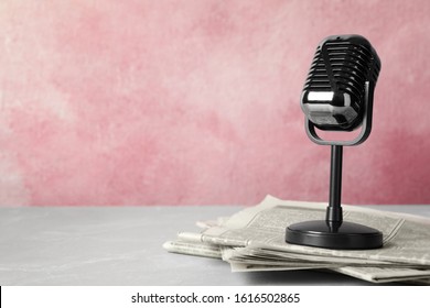 Newspapers and vintage microphone on table, space for text. Journalist's work - Shutterstock ID 1616502865