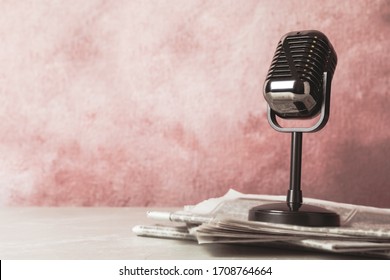 Newspapers and vintage microphone on table, space for design. Journalist's work - Shutterstock ID 1708764664