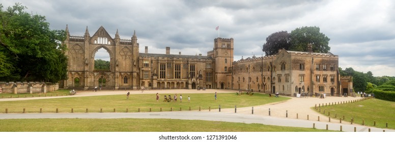 Newstead, Nottinghamshire, England, UK - August 3, 2018: Wide panorama of Newstead Abbey.  A late home of English poet, Lord Byron. Popular recreation place with resting people and playing children