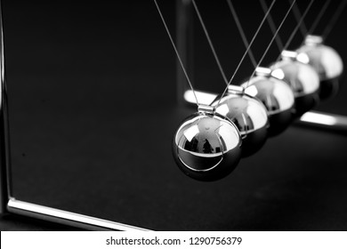 Newtons Cradle balancing balls, business concept in studio - Shutterstock ID 1290756379