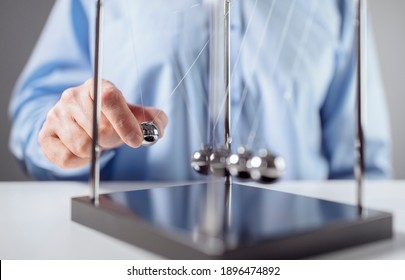Newton's cradle businessman releasing ball concept for cause and effect - Shutterstock ID 1896474892