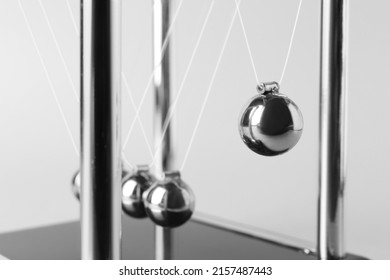 Newton's cradle on light background, closeup. Physics law of energy conservation