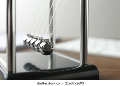 Newton's cradle on wooden table, closeup. Physics law of energy conservation - Shutterstock ID 2168792693